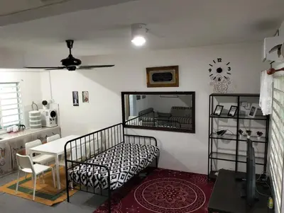 a bedroom with a bed and a table in a room at lost world of tambun homestay in Ipoh