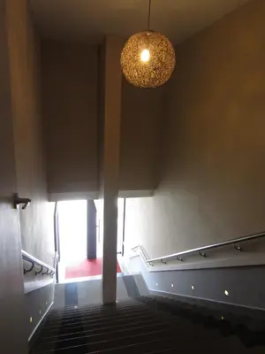 a hallway with a chandelier and stairs in a building at Radiant Hotel in Sitiawan