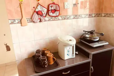 a kitchen counter with a toaster and cups on it at Tambun homestay in Ipoh
