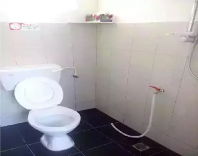 a bathroom with a white toilet in a stall at We Love GuestHouse in George Town