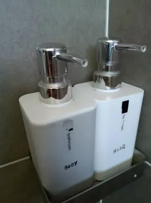 two toilets sitting next to each other in a bathroom at Pangkor Happy Villa @ 88 Resort Villa Riadah in Kampong Sungai Udang