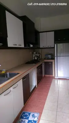 a kitchen with white cabinets and a tile floor at Ar Rayyan Apartments Prima Villa in Tanah Rata
