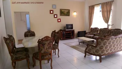 a living room with a table and chairs at Ar Rayyan Apartments Prima Villa in Tanah Rata