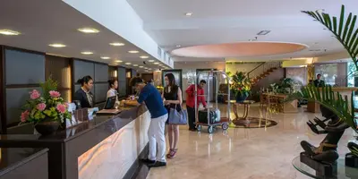 a group of people standing at a counter in a salon at Pearl View Hotel Prai, Penang in Perai