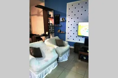 a living room with two chairs and a tv at Bintang Maya Residence cozy and comfortable stay in Sungai Petani