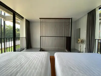 a bedroom with a white bed and a balcony at Ten Mentigi in Tanah Rata