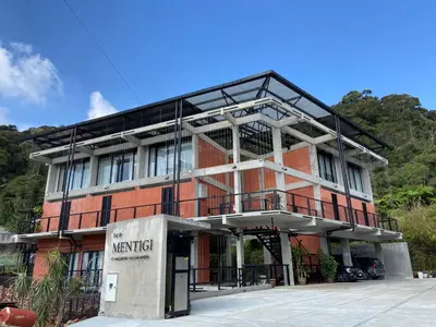a large red brick building with a sign on it at Ten Mentigi in Tanah Rata
