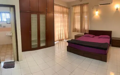 a bedroom with a purple bed in a room at Awani Homestay Seberang Jaya in Permatang Janggus