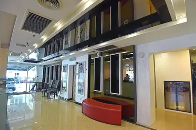 a lobby with a red chair in a building at Jindagu Hotel Ipoh in Ipoh