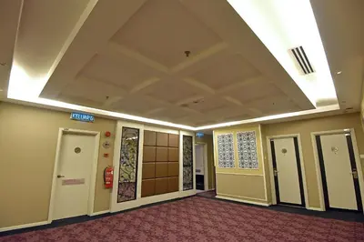 a hallway in a building with a ceiling at Jindagu Hotel Ipoh in Ipoh