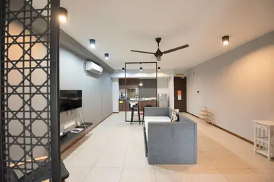 a living room with a couch and a tv at The Landmark by Katana - Your Home Away From Home in Tanjong Tokong