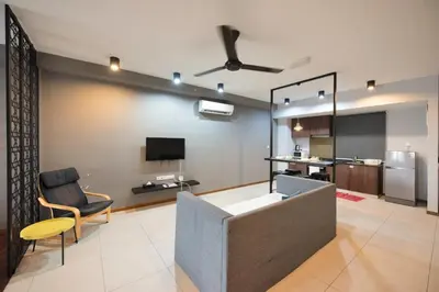 a living room with a couch and a tv at The Landmark by Katana - Your Home Away From Home in Tanjong Tokong