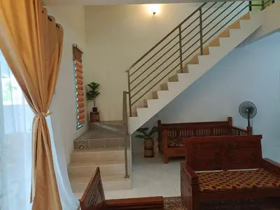 a staircase in a house with a stair case at Kayu Cengal Homestay in Seri Iskandar