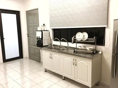 a kitchen with a sink and a microwave at SS Ipoh Comfort Homestay - Taman Bertuah in Ipoh