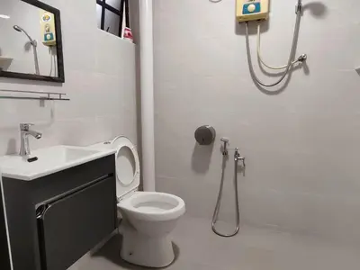 a bathroom with a toilet and a sink and a shower at SS Ipoh Comfort Homestay - Taman Bertuah in Ipoh