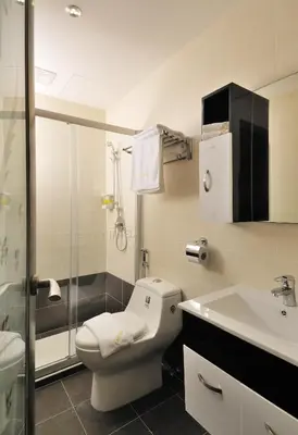a bathroom with a toilet and a sink and a shower at ERNES Hotel Alma Bukit Mertajam in Bukit Mertajam