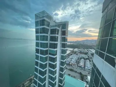 a tall building next to a body of water at Maritime Seaview Hotel by SS Setia Resort in George Town