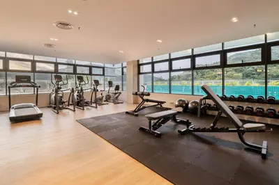 a gym with a row of treadmills and exercise machines at Zenith Hotel Cameron in Tanah Rata