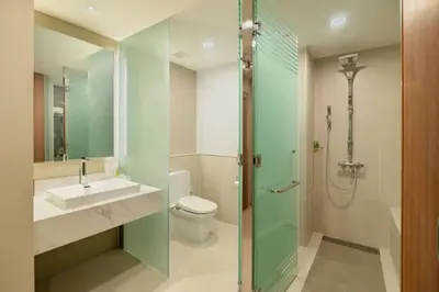 a bathroom with a shower and a sink and a toilet at Zenith Hotel Cameron in Tanah Rata