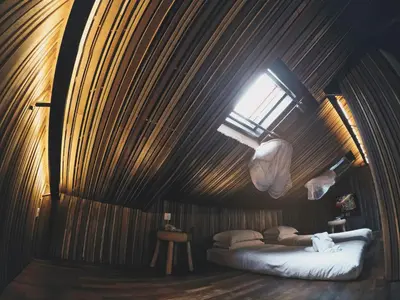 a bedroom with a bed in a wooden wall at The Happy 8 Retreat @ Old Town Ipoh in Ipoh