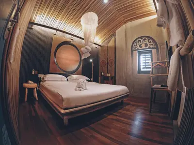 a bedroom with a bed with a cat sitting on it at The Happy 8 Retreat @ Old Town Ipoh in Ipoh