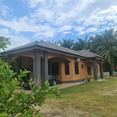 a house with a car parked in front of it at Enalys Homestay untuk orang islam sahaja in Kampung Bota Kiri
