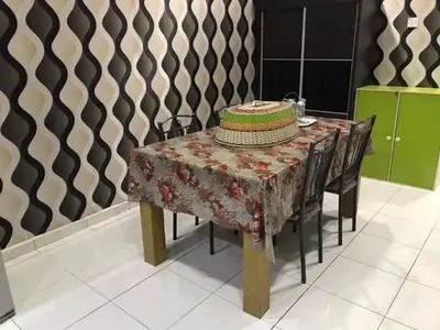 a table with a hat sitting on top of it at No 96 Nazirin Homestay Lumut in Lumut