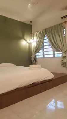 a bedroom with a large bed with a window at Tulip Hotel in Ipoh
