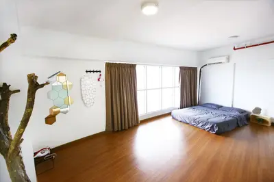 a bedroom with a bed and a wooden floor at Private Beanie (Private Cinema, Swing & more) at CEO Penang in Bayan Lepas