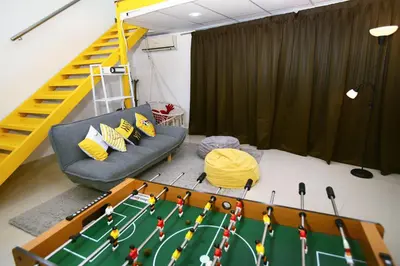 a living room with a couch and a table at Private Beanie (Private Cinema, Swing & more) at CEO Penang in Bayan Lepas