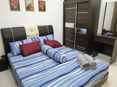 a bed with two pillows on it in a room at Onies Homestay Lumut Manjung in Lumut