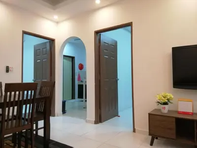 a living room with two doors and a tv at Onies Homestay Lumut Manjung in Lumut