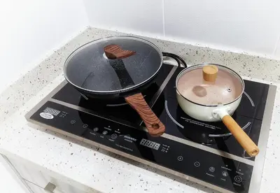 a pot and a pan on top of a stove at One Life Four Season Waterpark Guest House Manhattan Condominium in Ipoh