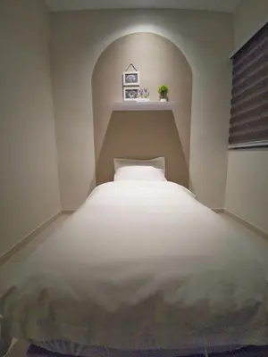 a bedroom with a white bed in a room at One Life Four Season Waterpark Guest House Manhattan Condominium in Ipoh