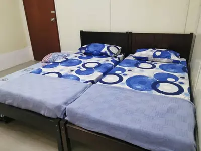 two beds sitting next to each other in a bedroom at Homestay Teduhan Gunung, Gopeng in Gopeng