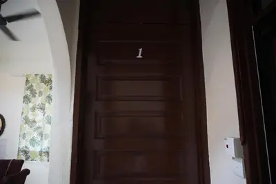 a wooden door with a number on it at Minden Stay in Gelugor