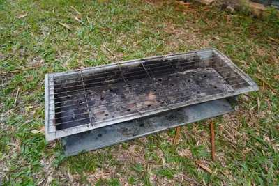 a grill sitting on the grass in the yard at Minden Stay in Gelugor