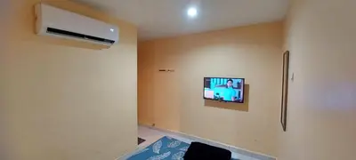 a room with a flat screen tv on the wall at RELAX HOTEL in Sungai Petani