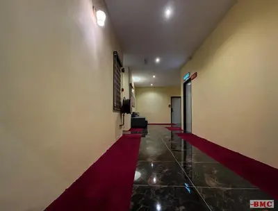 a hallway with a red carpet in a building at BMC Hotel in Ipoh