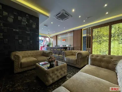 a living room with couches and a table at BMC Hotel in Ipoh