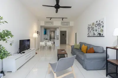 a living room with a couch and a tv at Beacon Executive Suite Penang in George Town