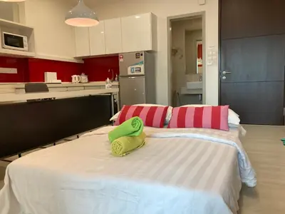 a large bed with two towels on it in a kitchen at Straits Garden Suite Jelutong Georgetown in George Town