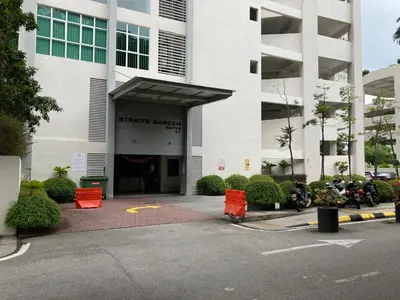 a large white building with motorcycles parked in front of it at Straits Garden Suite Jelutong Georgetown in George Town