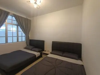 a bedroom with two beds and a window at Dream 1 in Cameron Highlands