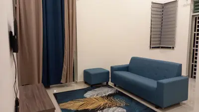a blue chair sitting in a living room at Homestay Zaki D'Gerik in Gerik