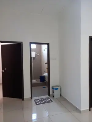 a bathroom with a toilet and a door with a rug at Homestay Zaki D'Gerik in Gerik