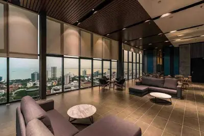 a living room with couches and tables and windows at Tropicana 218 Macalister Seaview Water Purifier Studio in George Town