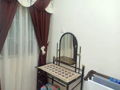 a mirror sitting in front of a window with curtains at KH Homestay Comfy N Calm in Seri Manjung