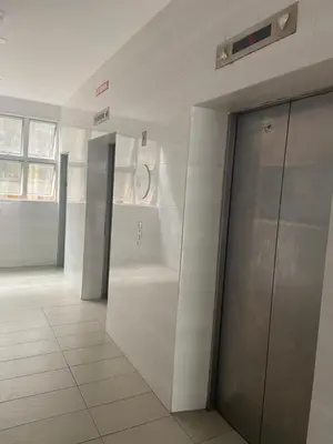 a hallway with two elevators in a building at GUNONG HOMESTAY at Golden Hills CameronHighlands in Cameron Highlands