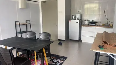 a kitchen with a table and a white refrigerator at GUNONG HOMESTAY at Golden Hills CameronHighlands in Cameron Highlands